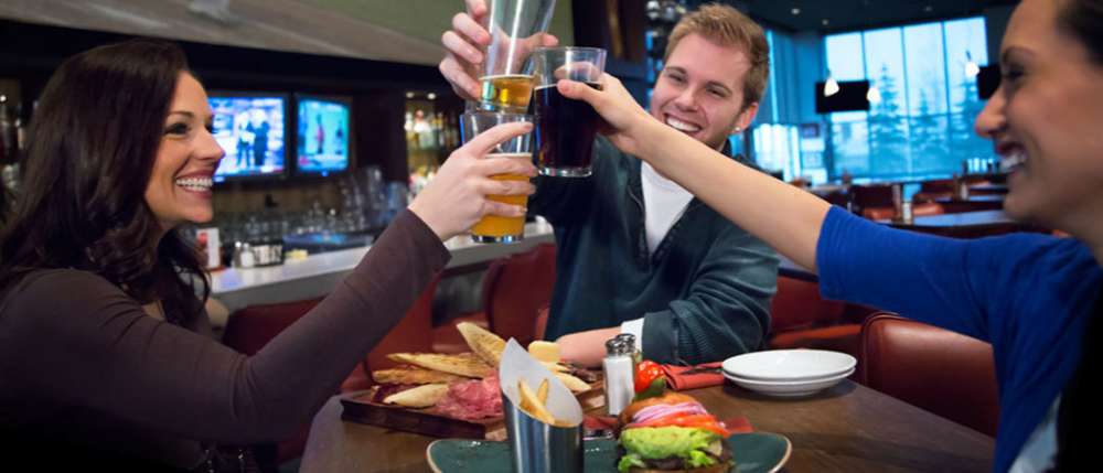 Friends cheersing at a pub table
