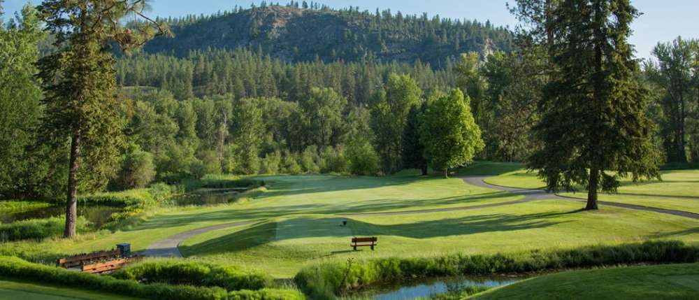 Green golf course with walking path
