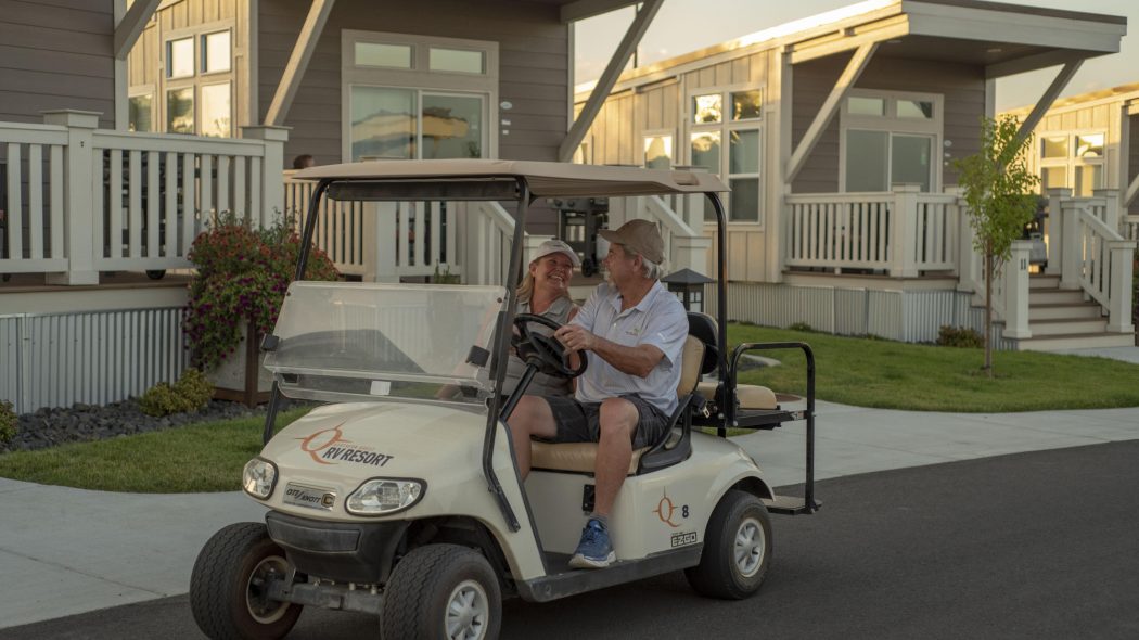 A couple riding in a golf cart
