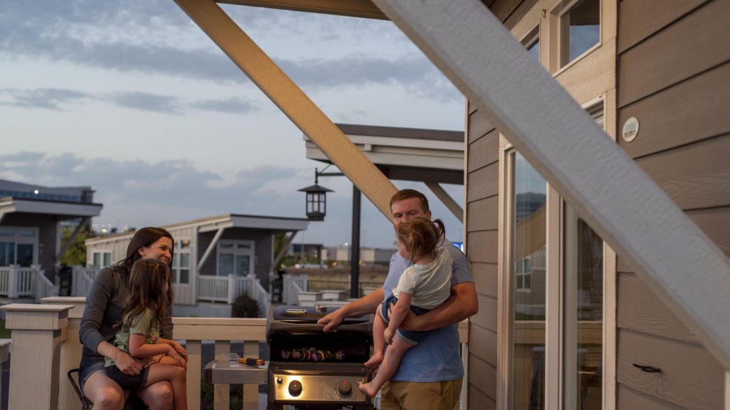 A family cooking dinner on a barbecue grill
