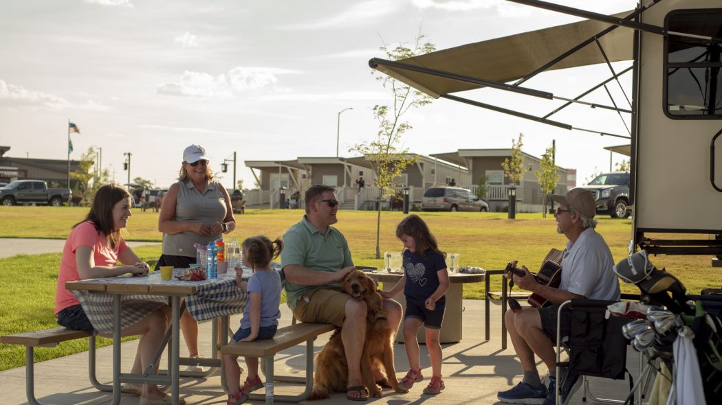 A family sitting at a picnic table